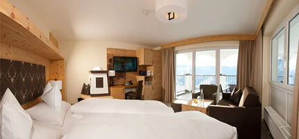 Swiss stone pine suite in modern alpine chic and panoramic view from the balcony