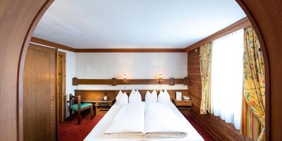 The rustic furnishings of the Birgkar double room with its large double bed next to the window